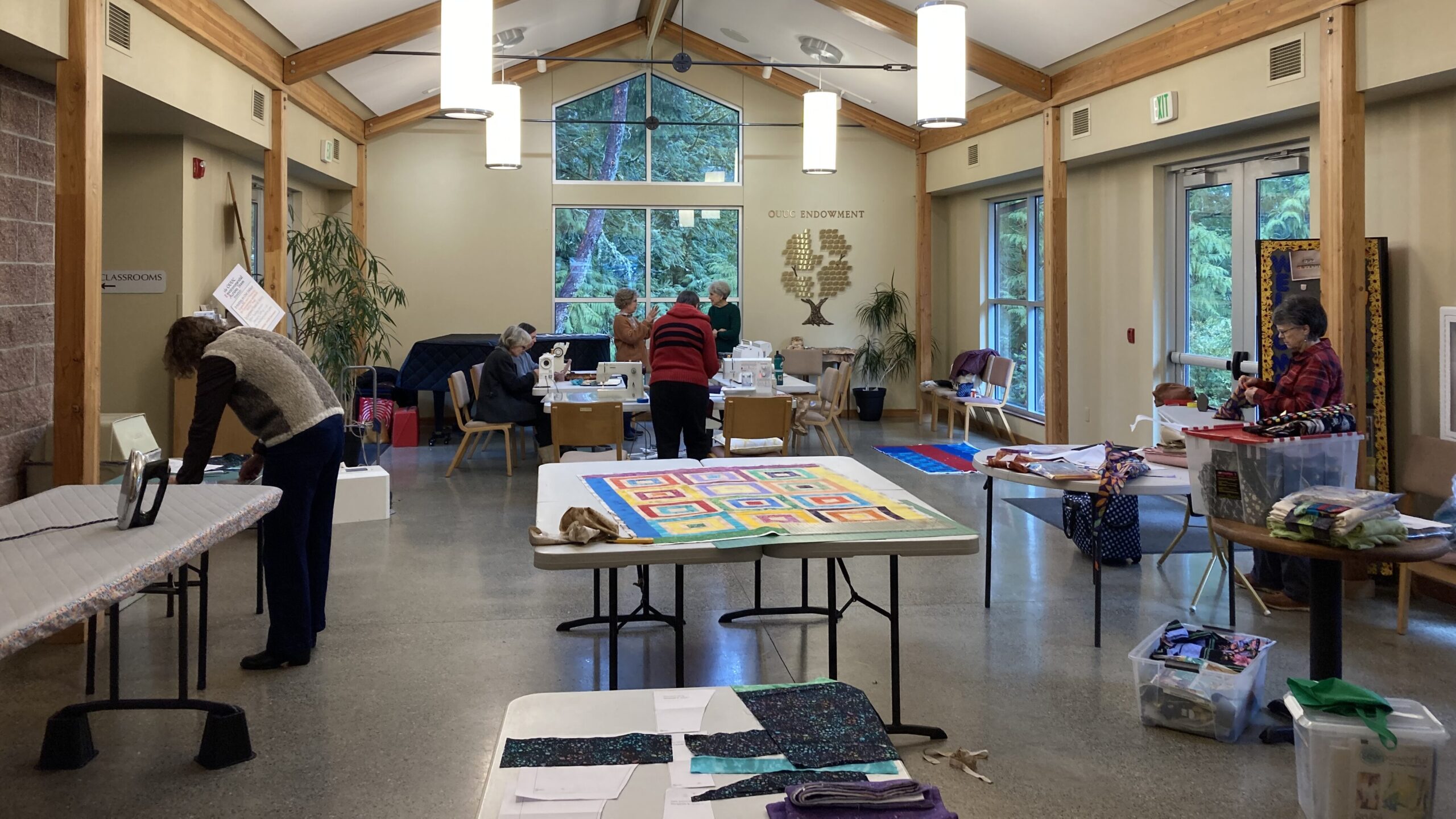 the Sewing Ministry Team working on sewing projects in the Commons at OUUC